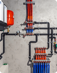 Plumber working on pipes under a sink